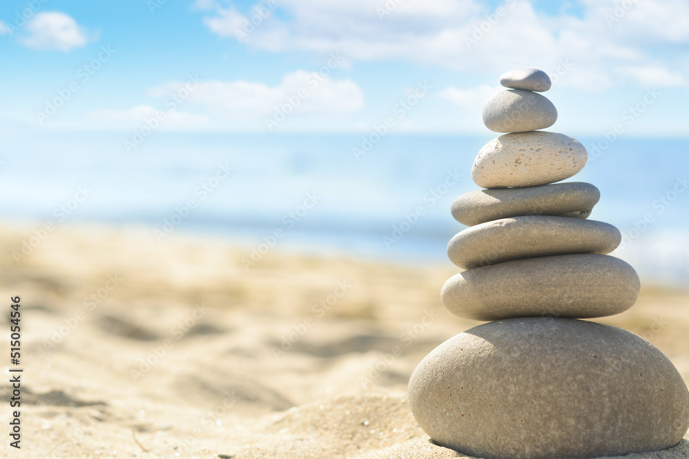 Stack of stones on sandy beach, closeup. Space for text Stack of stones on sandy beach, closeup. Space for text