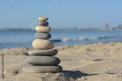 Stack of stones on sandy beach  space for text
