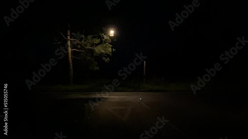 police car at night on country lane, UK police force car with police sirens and police car lights flashing video footage driving past fast