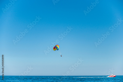 Rainbow paragliding in the sea