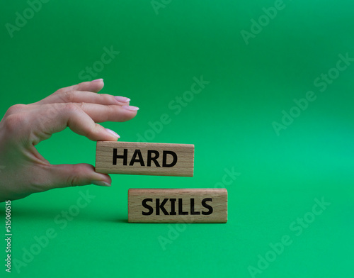 Hard skills symbol. Wooden blocks with words Hard skills. Beautiful green background. Businessman hand. Business and Hard skills concept. Copy space.