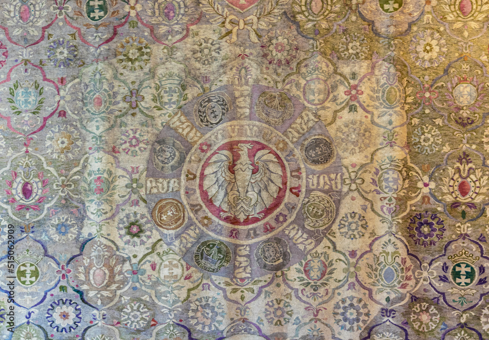 Antique woven woolen tapestry with coats of arms patterns
