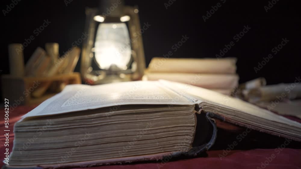 Worn history book of ancient times. Reading by kerosene lamp.
Reading the historical period book with the light of a kerosene lamp.
