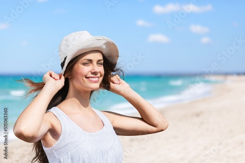 Canvas Print Luxury beach vacation elegant tourist woman walking relaxing at the beach
