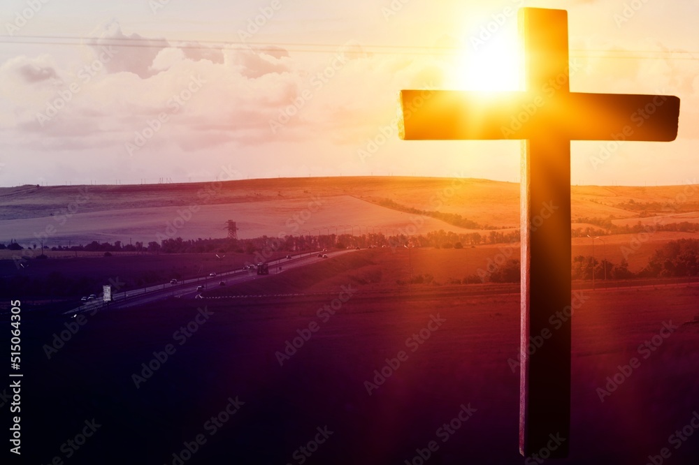 The concept of the Christian faith. Wooden cross, mountain and light