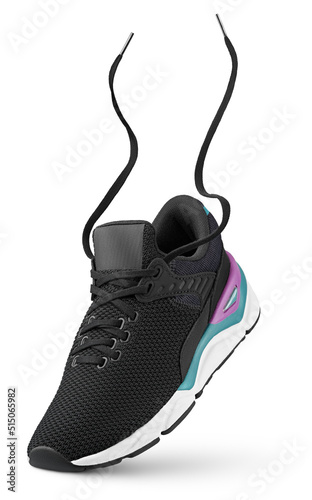 Black sneaker with flying laces stands on the tip isolated on white background. Running sport shoe with clipping path. Full Depth of Field