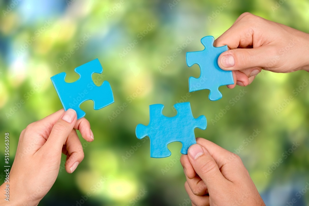 ESG concept of environmental, social, and governance. Hand of people holding a piece of jigsaw puzzle in solving environmental, social ESG concept of environmental, social, and governance. Hand of people holding a piece of jigsaw puzzle in solving environmental, social