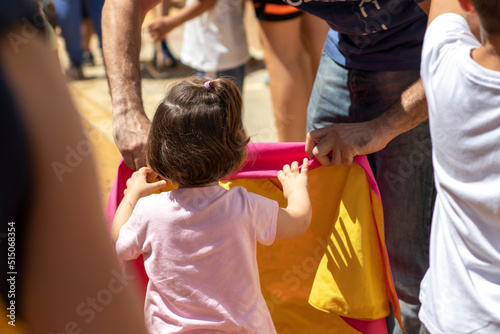 The confinement of the bulls, is celebrated in the Patron Saint Festival of San Juan del Puerto, from June 19 to 23. A little girl from behind holding a bullfighting cape.