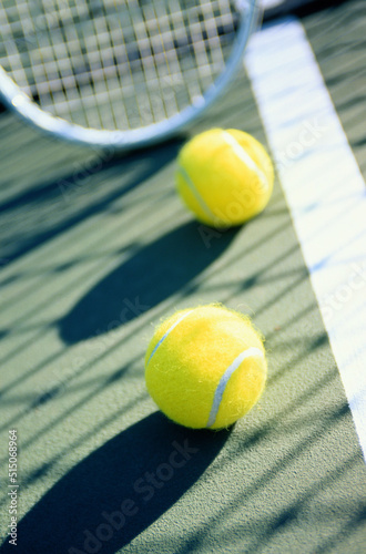 tennis racket and ball on court © riyas hassan
