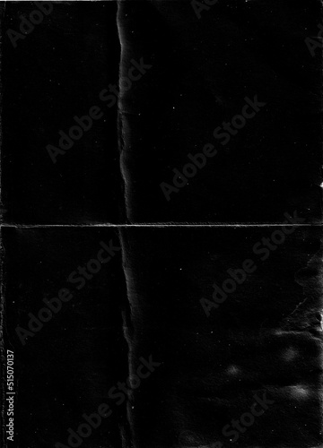 Fotografía Folded paper with grungy texture in black background