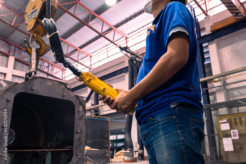 The construction crane in factory. remote control crane. employee crane forced remote in factory industrial