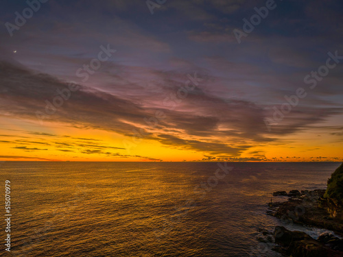 Sunrise over the sea with high cloud