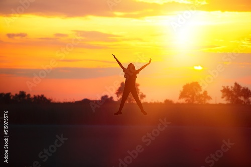 Happy human jumping on the top of mountain, celebrating success outdoor