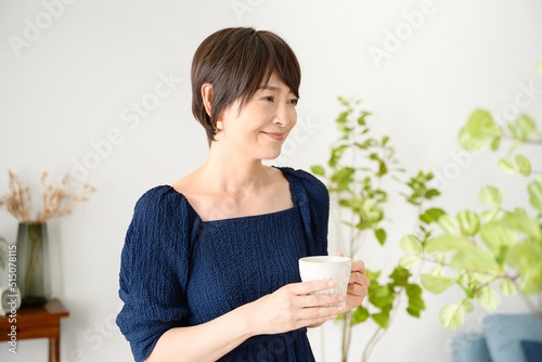 фотографія Woman relaxing with a cup of coffee, etc.