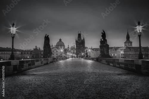 Black and white Charles bridge on Vltava river at night - Prague, Czech Republic