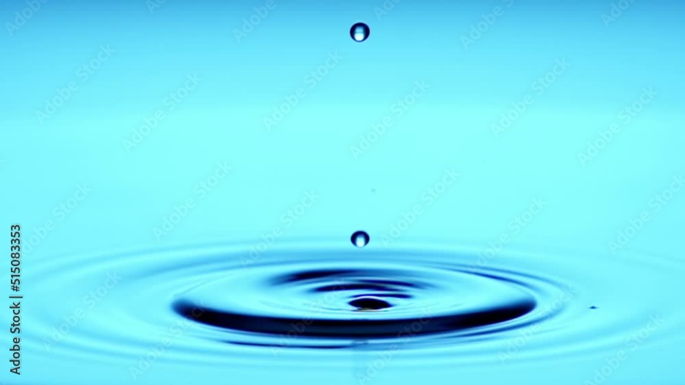 A single drop of water falling into a pool of water in slow motion. A single drop of water falling into a pool of water in slow motion.