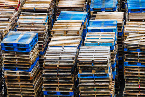 Empty shipping pallets stacked up after emptying their cargo.