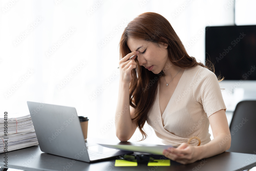 Serious beautiful young woman typing on laptop in a bright modern office, Charming asian businesswoman sitting working on laptop in office. Serious beautiful young woman typing on laptop in a bright modern office, Charming asian businesswoman sitting working on laptop in office.