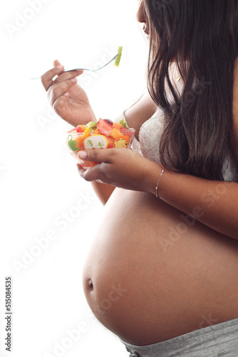 Pregnant woman eating fruits white background, Space for text
