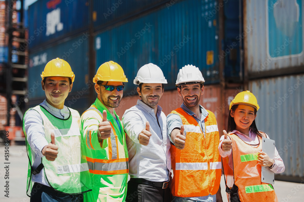 Group of workers and engineers with workers giving thumbs up in factory. Successful diverse teamwork standing in workplace. Group of workers and engineers with workers giving thumbs up in factory. Successful diverse teamwork standing in workplace.