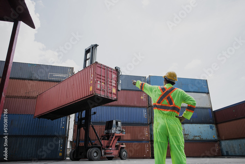 worker control container loading from cargo ship for export import container control industrial cargo ship, Engineer dock worker wear safety uniform check control loading freight cargo container