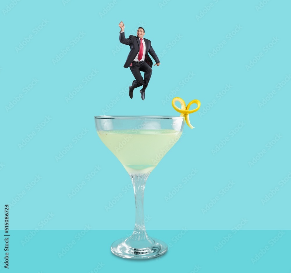 Contemporary art collage. Happy cheerful man jumping into refreshing tasty cocktail with fruity taste. Concept of alcohol, addiction, party, taste. Contemporary art collage. Happy cheerful man jumping into refreshing tasty cocktail with fruity taste. Concept of alcohol, addiction, party, taste.