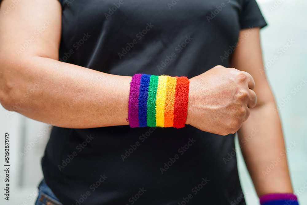 Fototapeta premium Asian woman with rainbow flag, LGBT symbol rights and gender equality, LGBT Pride Month in June.