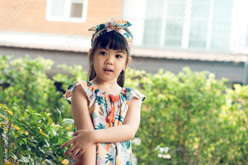 Young asian girl happily posing for a photo.