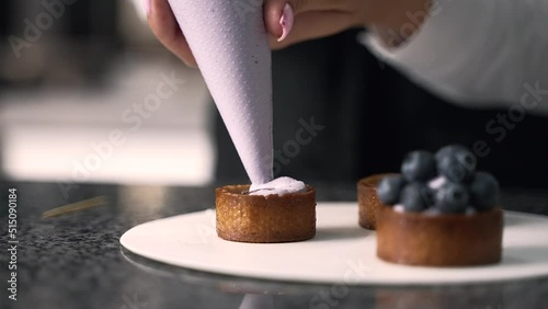 young girl chef makes desserts. bakes sweets and cakes. makes blanks and prepares fruits for the filling. baking, dessert, sweets, complex cooking processes.