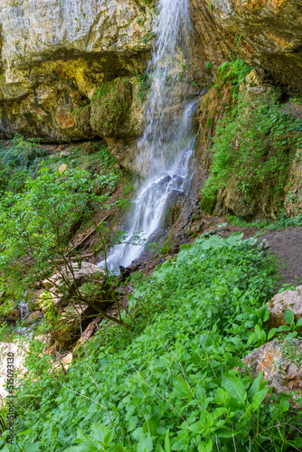 spring in nature  a natural park  a mountain river in a natural channel with rapids and waterfalls.