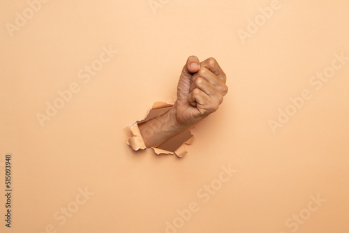 Close-up of Man hand isolated on a brown background