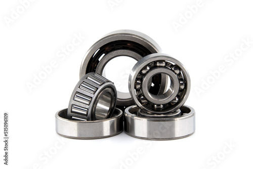 Group of various ball and roller bearings on white