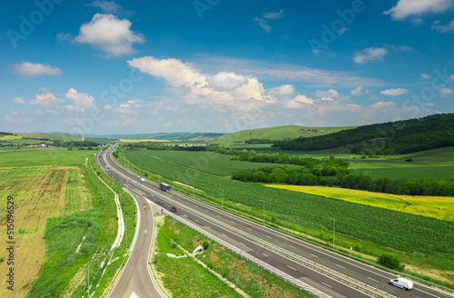 Aerial view over a highway in Romania that connects Sibiu with Alba-Iulia cities in Transylvania. Roads of Romania. Transportation industry.