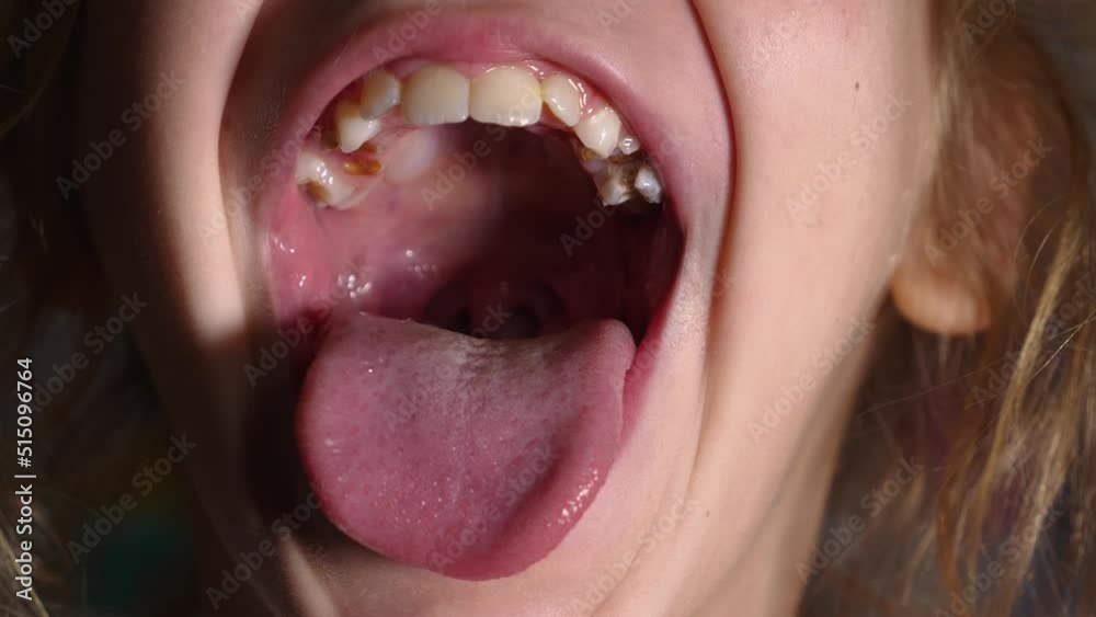 The girl opens her mouth wide and sticks out her long tongue ... 