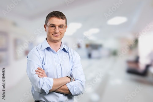 Young millennial confident man. Handsome guy pose alone at workplace or apartment. Professional occupation, freelance portrait, homeowner person concept