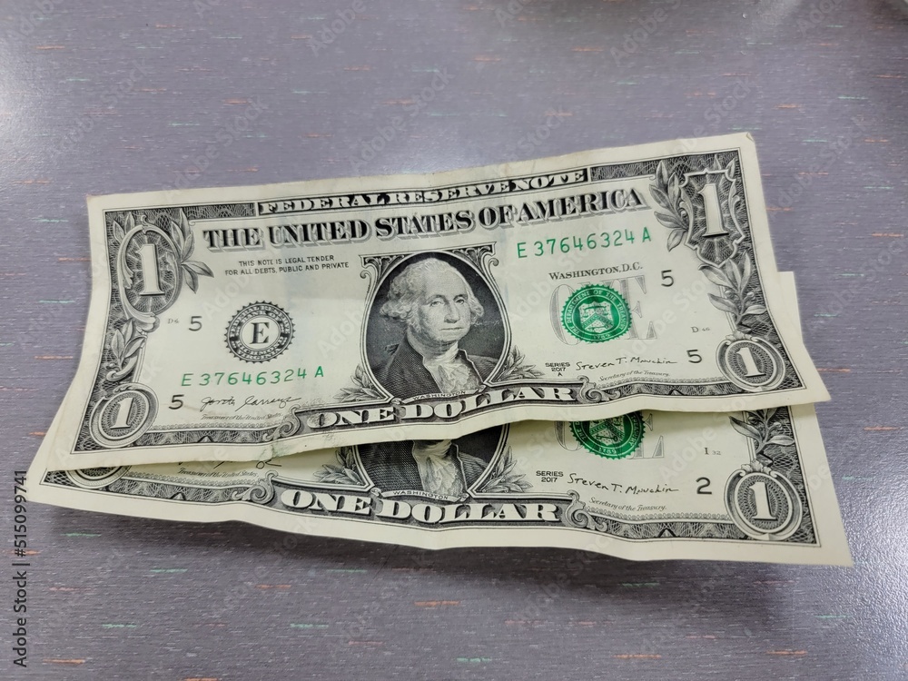 two one dollar united states of america bills on table - obrazy, fototapety, plakaty 