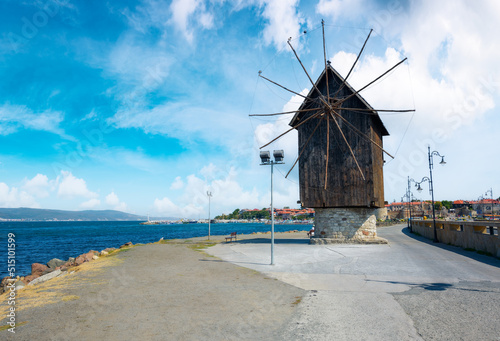 Fototapete nessebar, bulgaria - sep 2, 2019: old windmill on the embankment at the sea shore