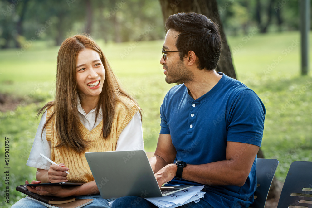 Partnership Student Friend holding Umbrella and working study with Partner support together at Park. Business young Couple Partner Discuss at the outdoor. Business Colleagues Outside Office. A Couple Partnership Student Friend holding Umbrella and working study with Partner support together at Park. Business young Couple Partner Discuss at the outdoor. Business Colleagues Outside Office. A Couple