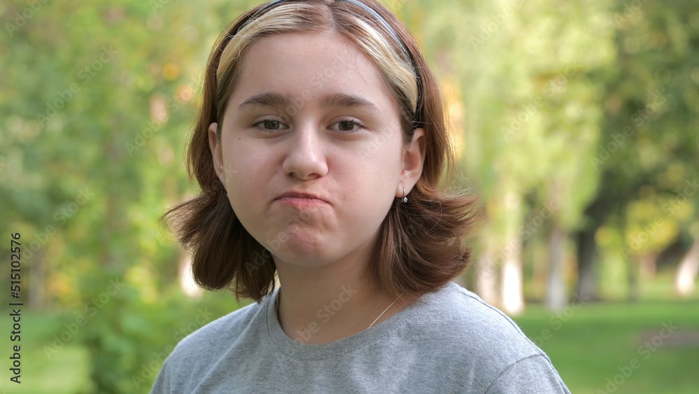 a teenage girl with an Asian appearance chews up leftovers and laughs with crumbs from her mouth. selective focus a teenage girl with an Asian appearance chews up leftovers and laughs with crumbs from her mouth. selective focus
