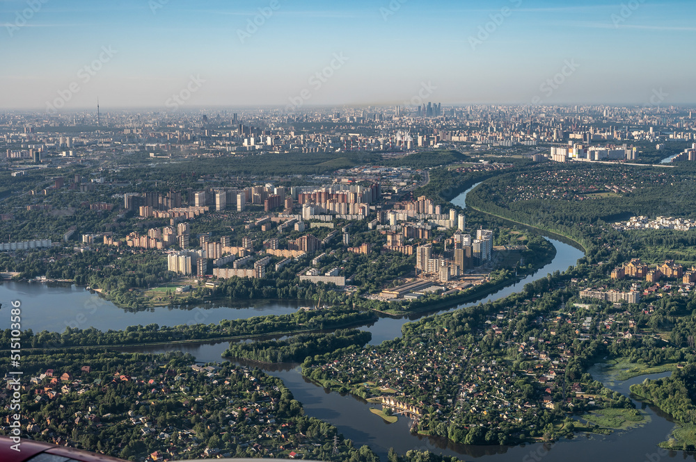 aerial photo of large city from an airplane window. view of city of Moscow through window from plane