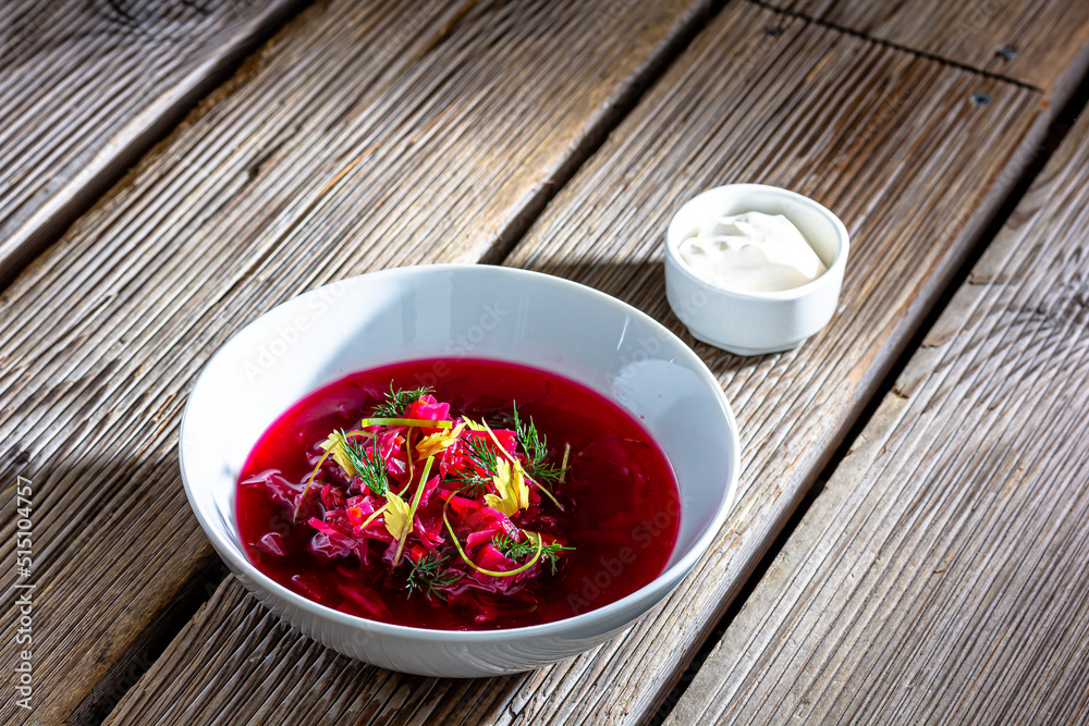 Vegetable cold soup with beet, cucumber, radsih and egg on wooden table Vegetable cold soup with beet, cucumber, radsih and egg on wooden table