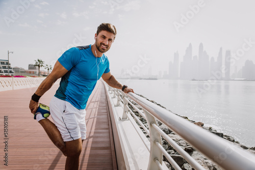 Fototapeta Naklejka Na Ścianę i Meble -  Handsome young man making functional training outdoor in the city. Fit muscular athlete making sport and fitness in an urban area