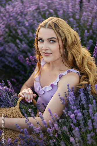 Girl in a lavender field. Woman in a field of lavender flowers at sunset in a white dress. France  Provence.