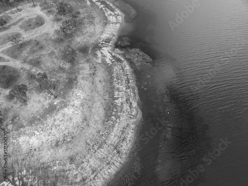 Eungella Dam Queensland Australia with low water levels showing texture in the and pattern in the shallows. photo