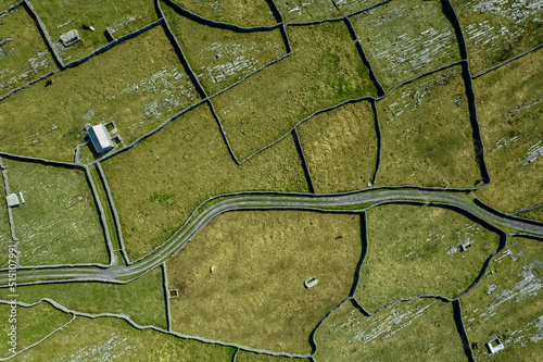 Green grass fields between stone fences of walls. Aerial top down view on meadow. Irish landscape. Aran Island, county Galway, Ireland. Popular and famous travel area. photo