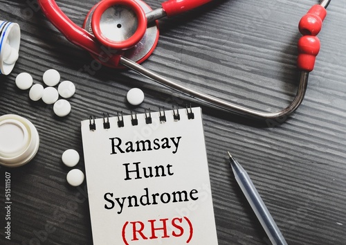 Notepad with the diagnosis Ramsay Hunt syndrome (RHS) on desk with stethoscope and pills. photo