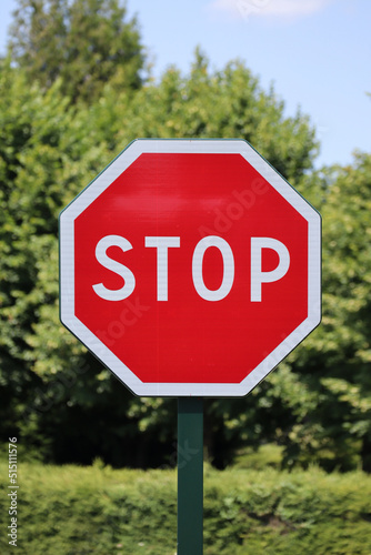 Stop sign with forest and trees background
