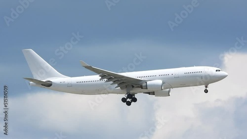 White generic plane no logo on contrasting sky with Clouds. tracking shot