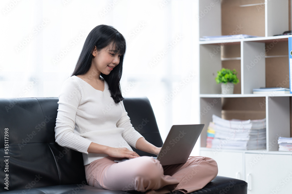 Asian woman working with laptop in her office. business financial concept. Asian woman working with laptop in her office. business financial concept.