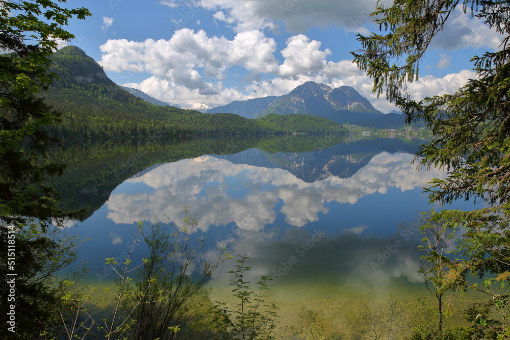 Fototapeta premium Reflections on the lake Altaussee viewed from the shore, Bad Aussee, Salzkammergut, Styria, Austria, Europe, with the Dachstein mountains in the background